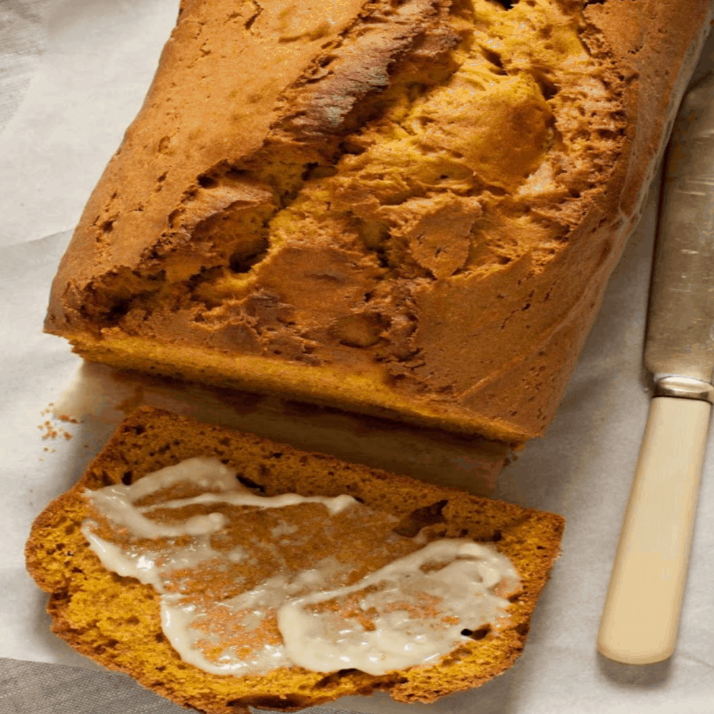 keto pumpkin bread sliced slathered with butter