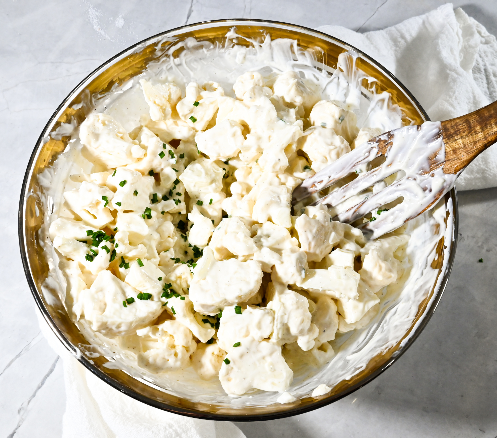 keto cauliflower salad in clear and gold bowl