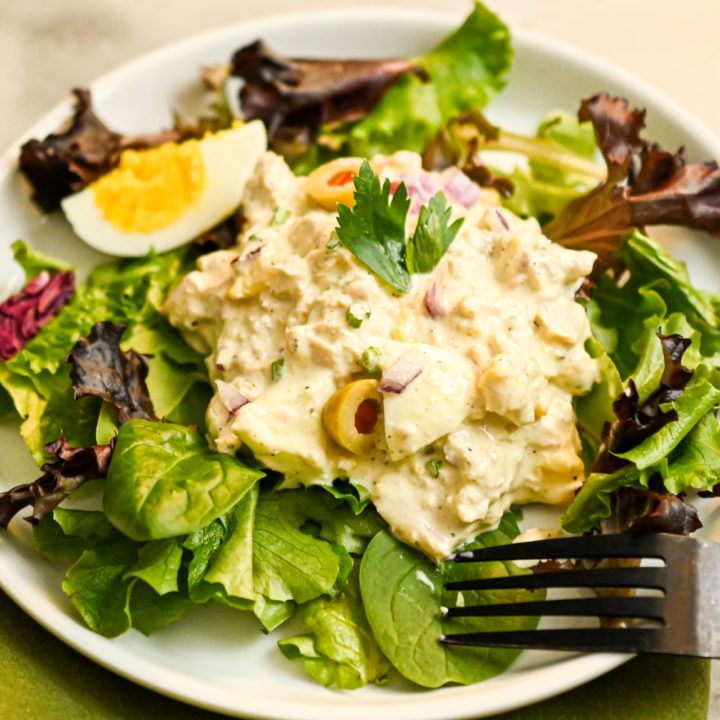 tuna and egg salad served on a bed of spring greens