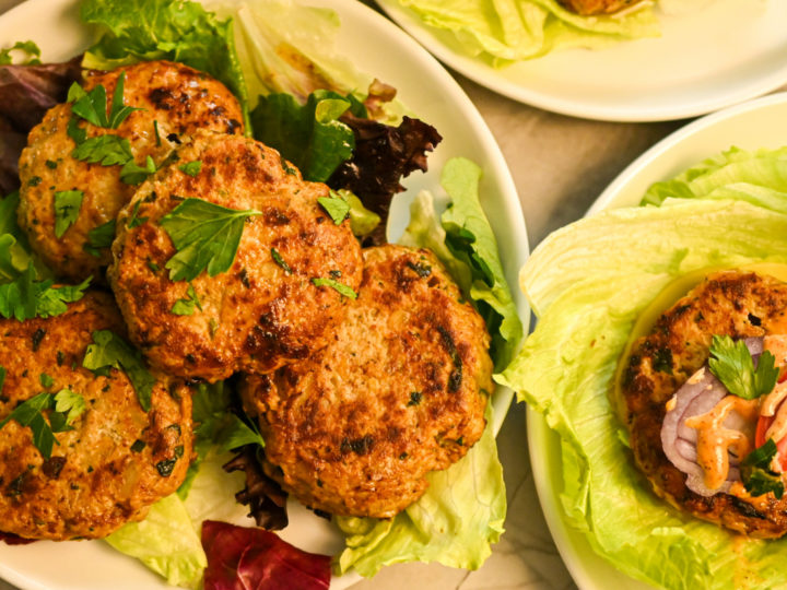 Low carb chicken burger patties on a bed of lettuce