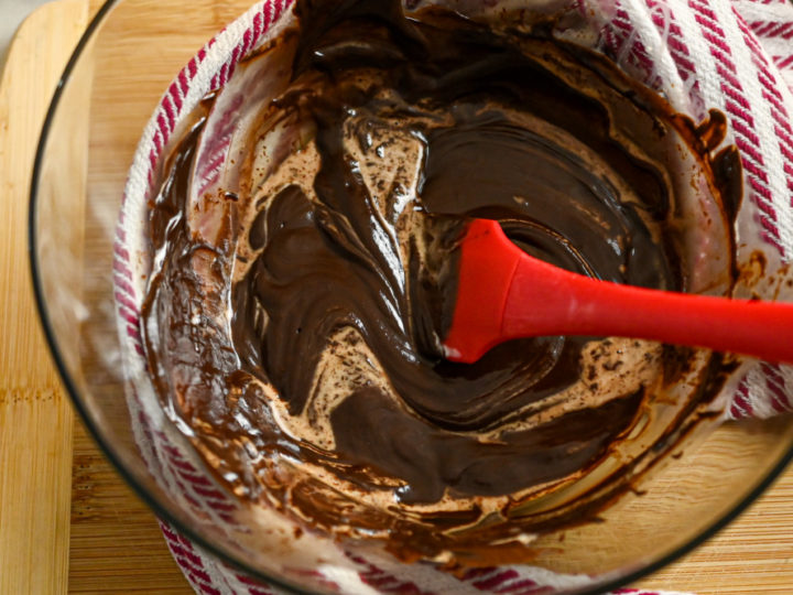 keto-friendly chocolate ganache being made in a clear bowl
