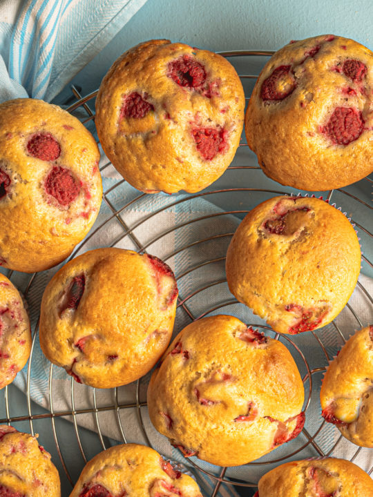keto raspberry coconut flour muffins cooling on a baking rack