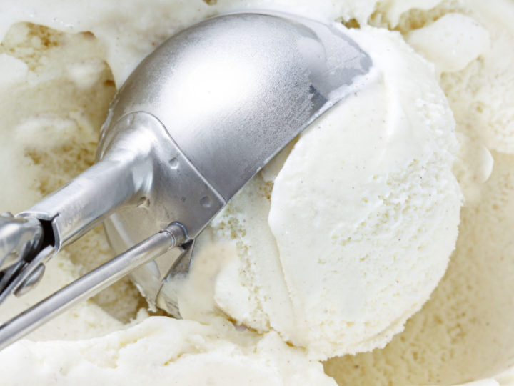 keto coconut ice cream being scooped from an ice cream maker