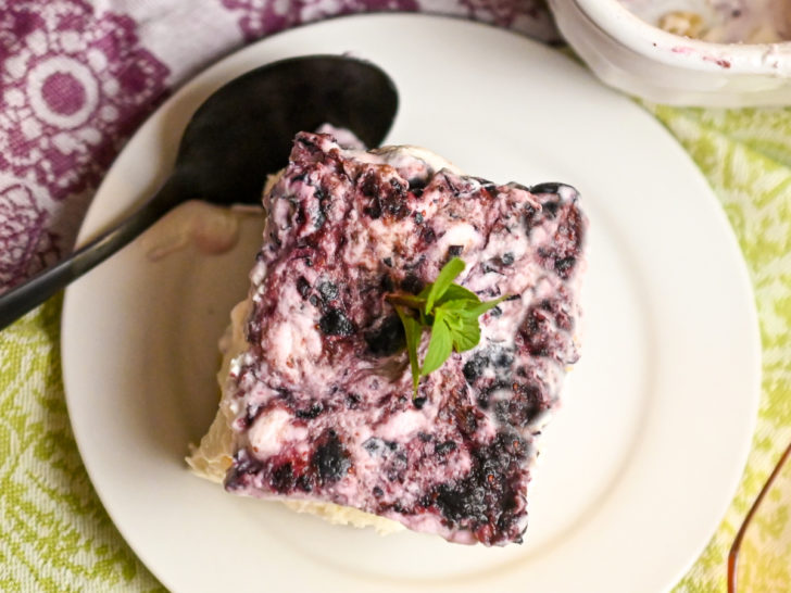 a slice of keto no bake blueberry cheesecake served on a small white plate