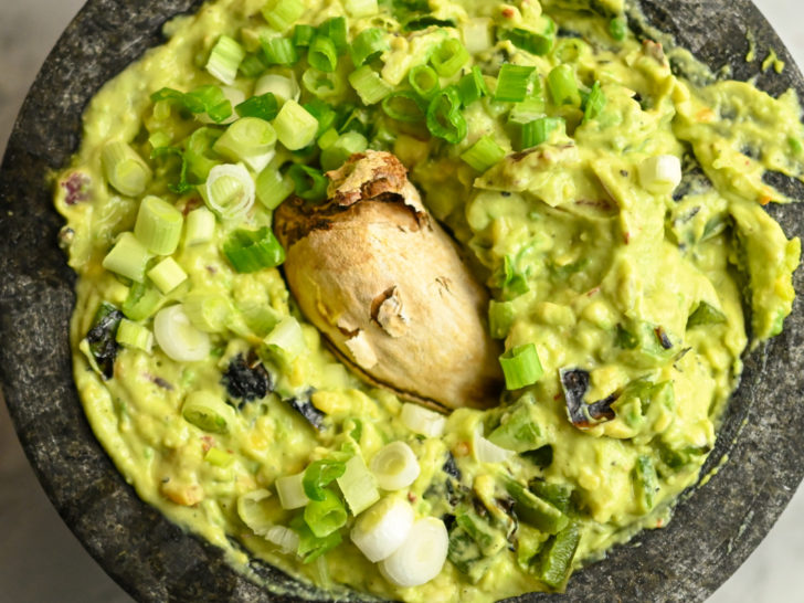 guacamole with an avocado seed placed in the center to help from turning brown