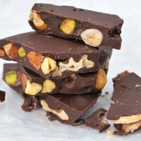 keto chocolate bark with mixed nuts on wax paper