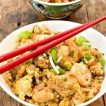 easy keto fried rice close up in a large white bowl and a small teal bowl