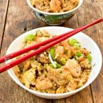 easy keto fried rice close up in a large white bowl and a small teal bowl