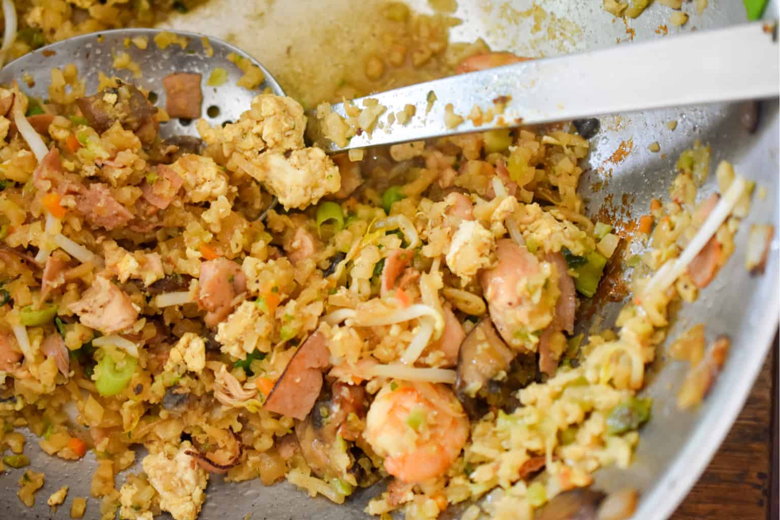 keto fried rice being cooked in wok