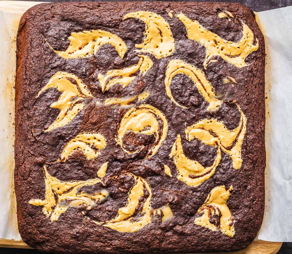 Keto peanut butter swirl brownies on parchment paper