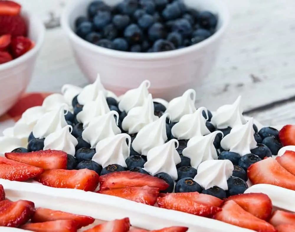 This delicious keto poke cake is decorated to look like an American flag. It's a perfect low carb poke cake for the 4th of July, Memorial Day, and Veterans Day. #ketopokecake #pokecake #lowcarbcake #lowcarbpokecake