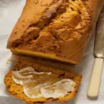 keto pumpkin bread sliced slathered with butter