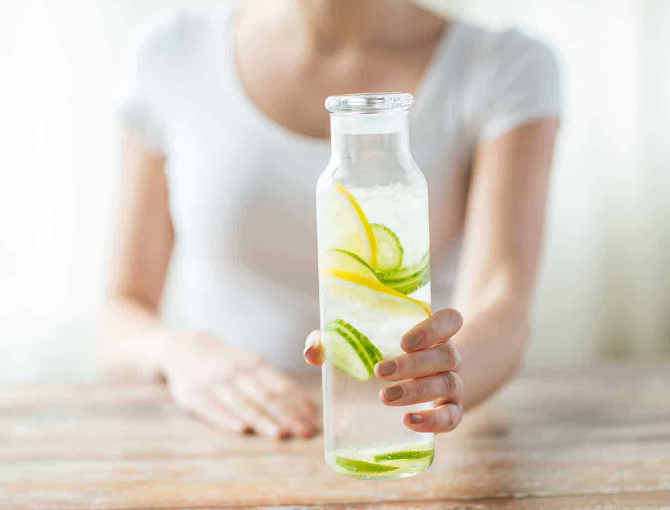 a water bottle with lemon and cucumber slices.