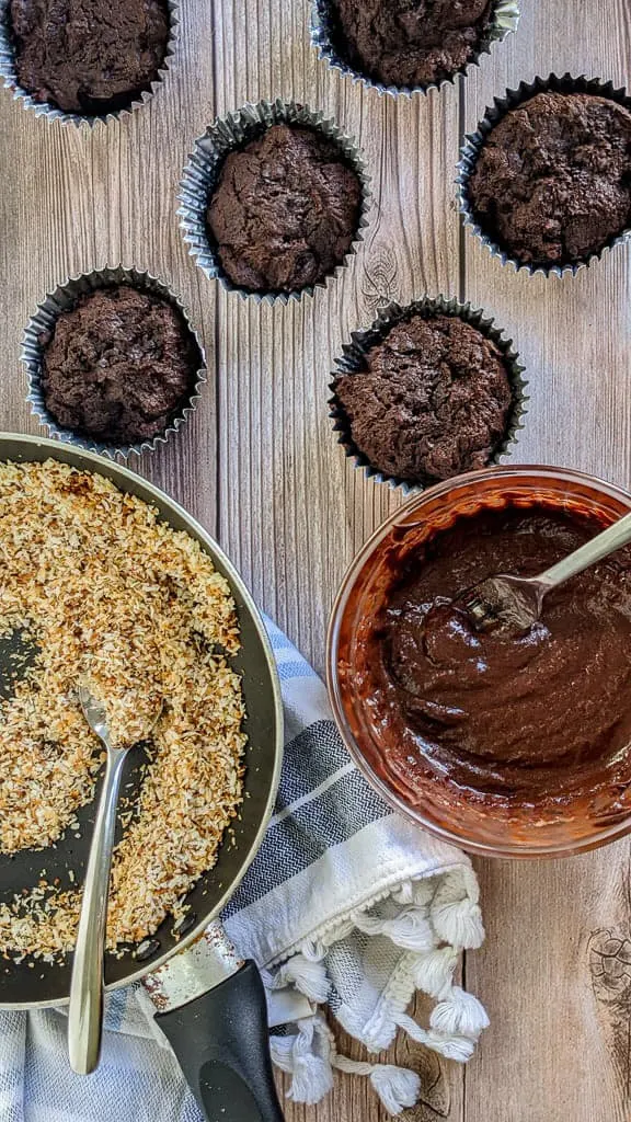 keto chocolate cupcakes ready to be iced and topped with toasted coconut