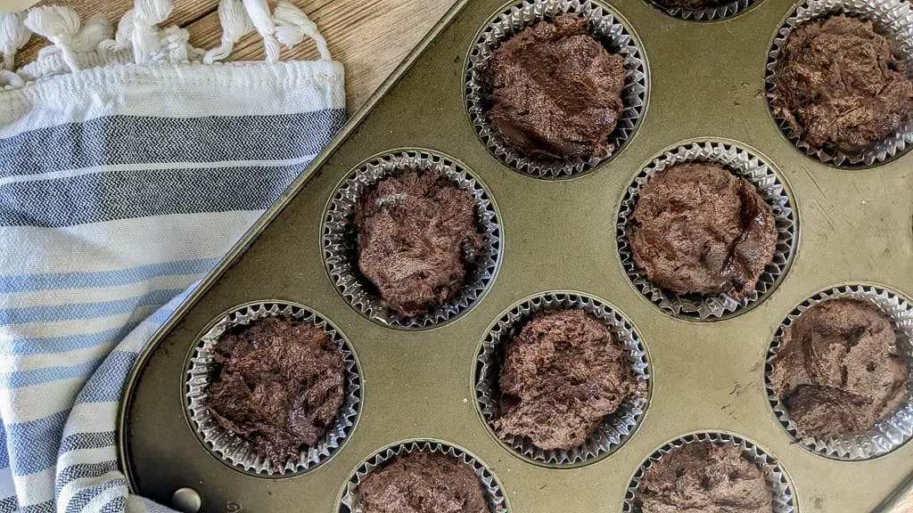 keto chocolate toasted coconut cupcakes in a muffin tin