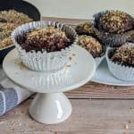 keto chocolate toasted coconut cupcakes on white plates