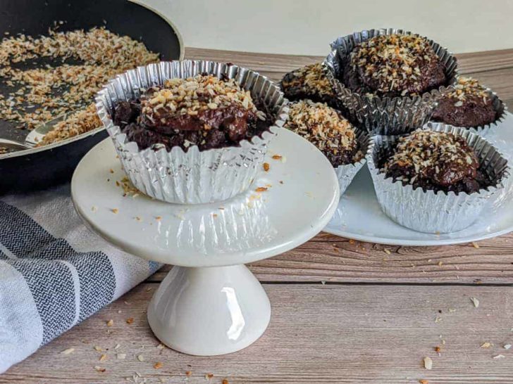 keto chocolate toasted coconut cupcakes on white plates