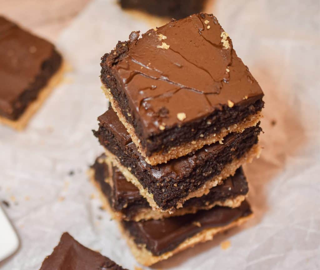 keto shortbread brownies stacked on parchment paper