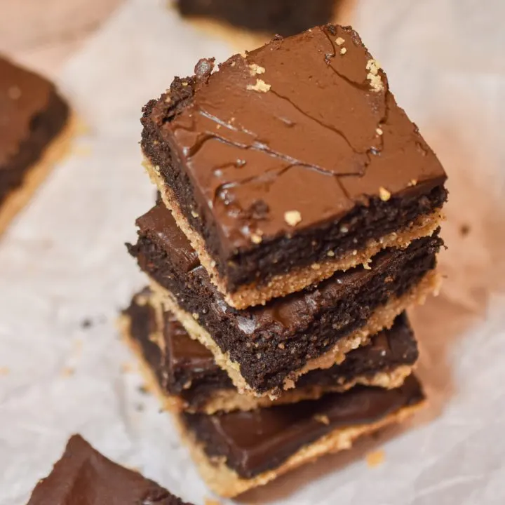 keto shortbread brownies stacked on parchment paper