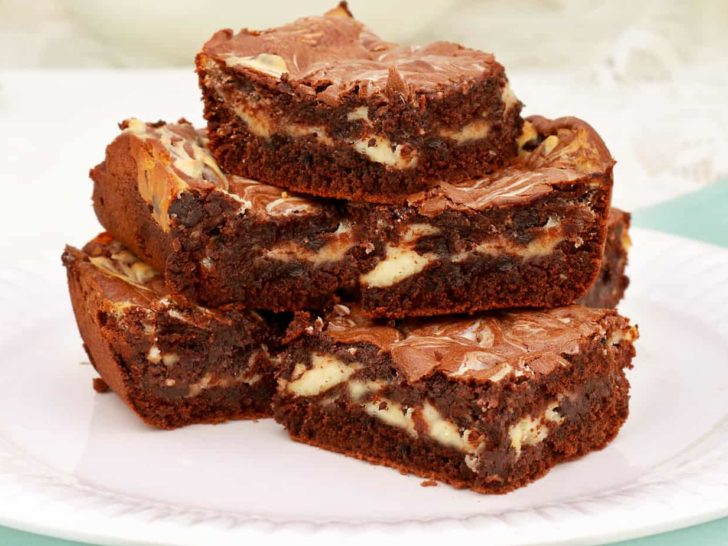 Keto cheesecake swirled brownies to curb your chocolate and cheesecake cravings.