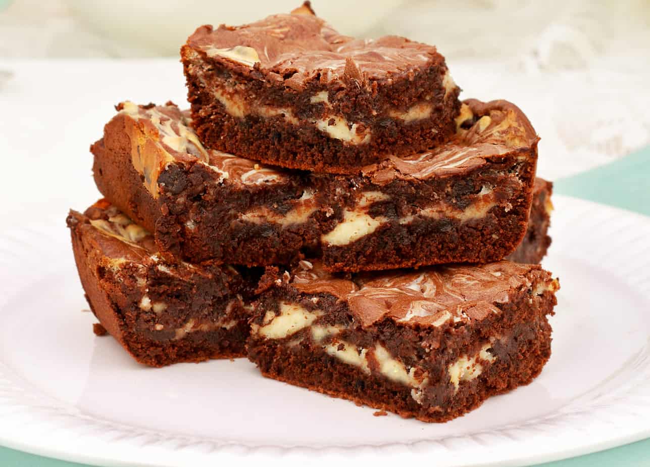 Keto cheesecake swirled brownies to curb your chocolate and cheesecake cravings.