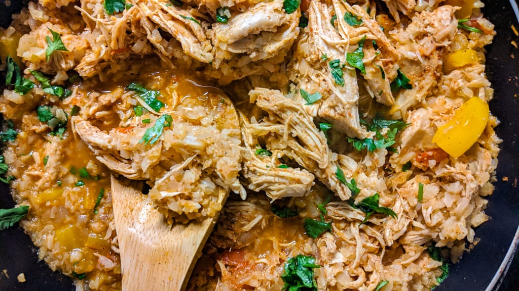 Keto Mexican Cauliflower Rice and Chicken in Skillet with Spoon Close Up