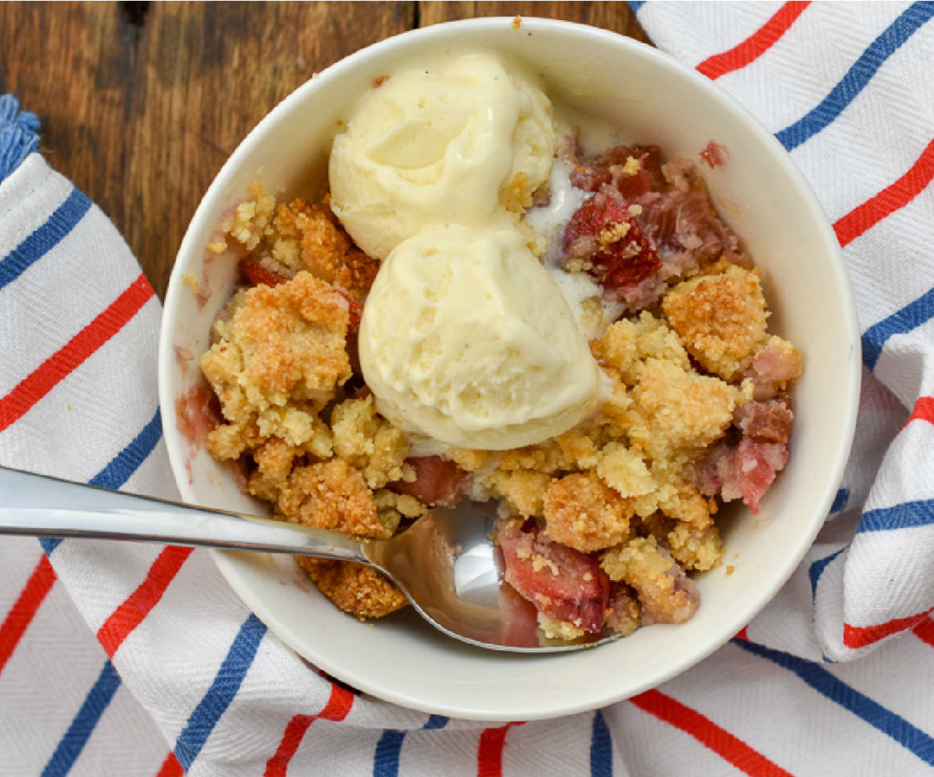 Keto strawberry rhubarb crisp served with low carb vanilla ice cream