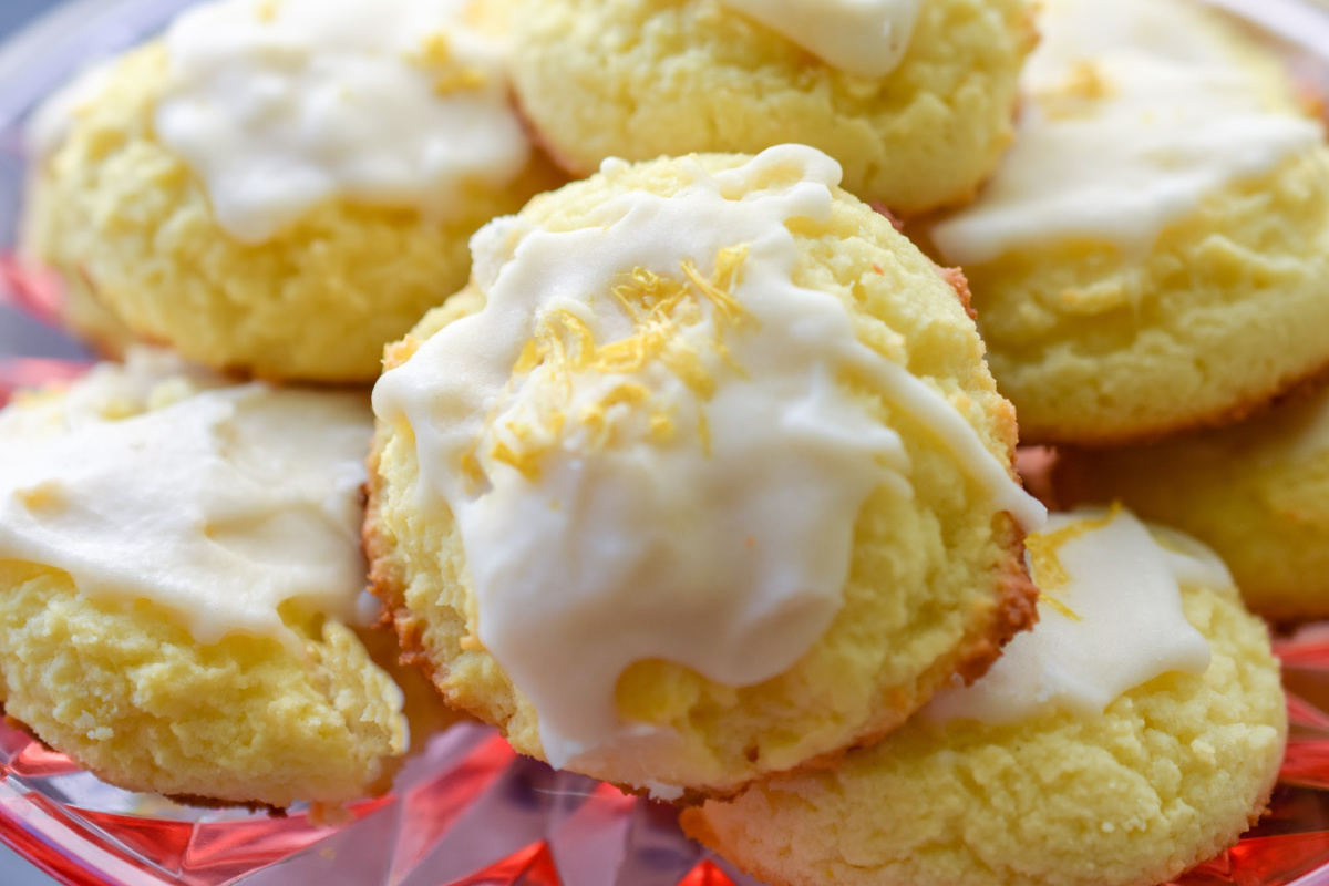 best keto lemon cookies on pink pedestal plate