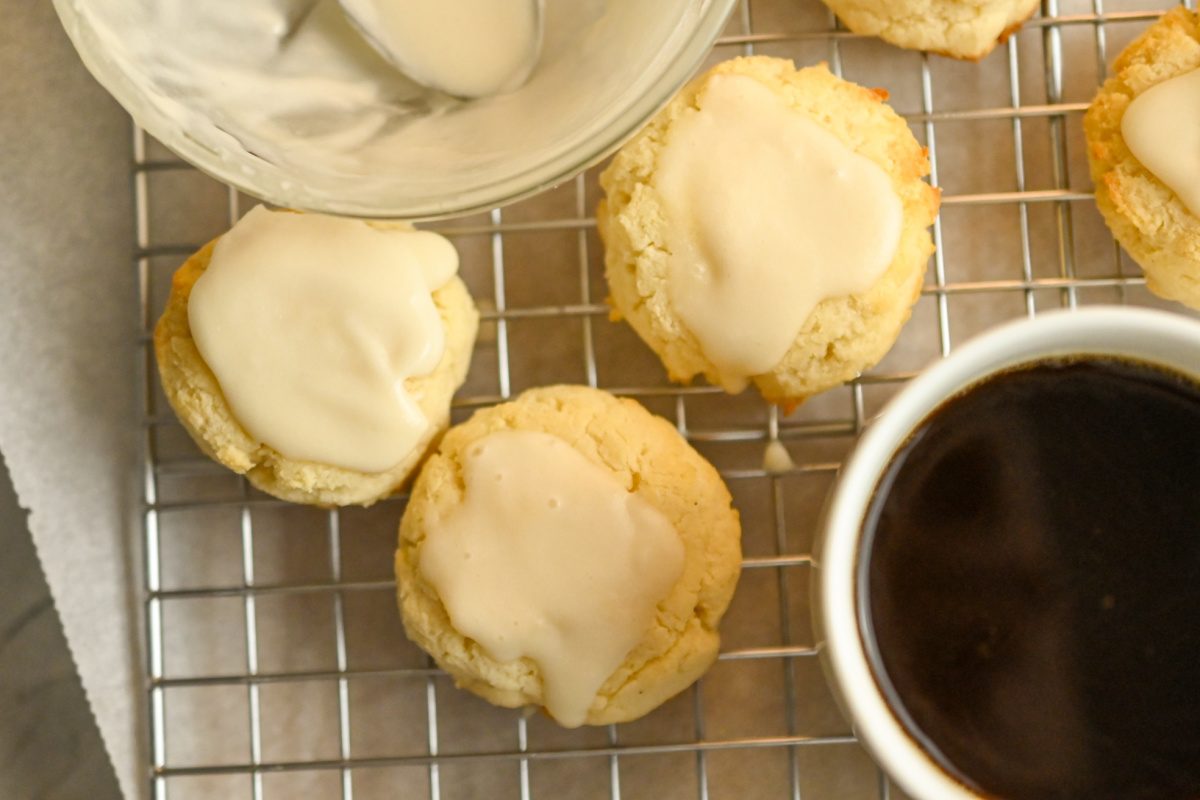 low carb cream cheese coconut flour cookies getting topped with vanilla icing