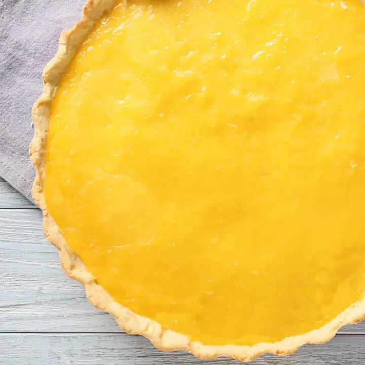 sugar-free lemon curd low carb pie whole on white wood counter