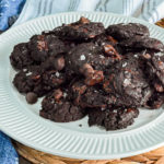keto chocolate flourless cookies with coarse sea salt on a white plate