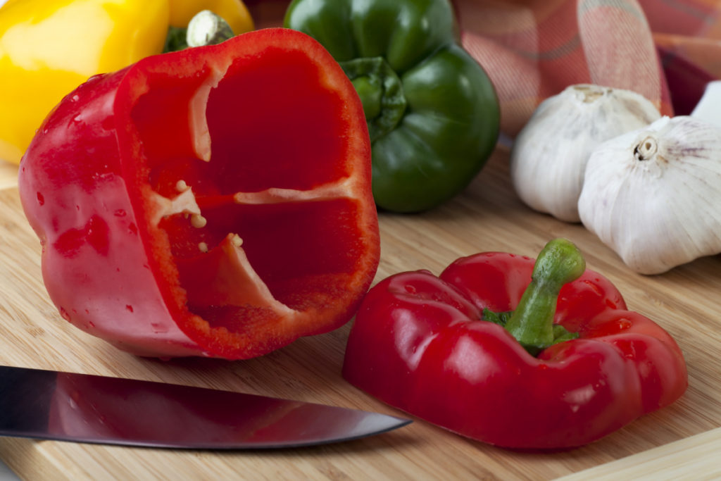 Colored bell peppers being prepped for stuffing