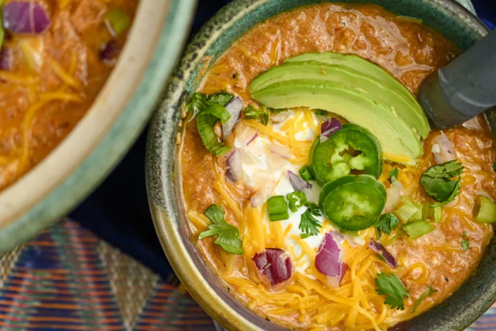 keto crockpot chicken chili served in a teal earthenware pot