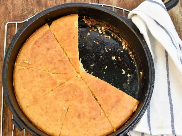 keto coconut flour cornbread with slices missing in a cast iron skille