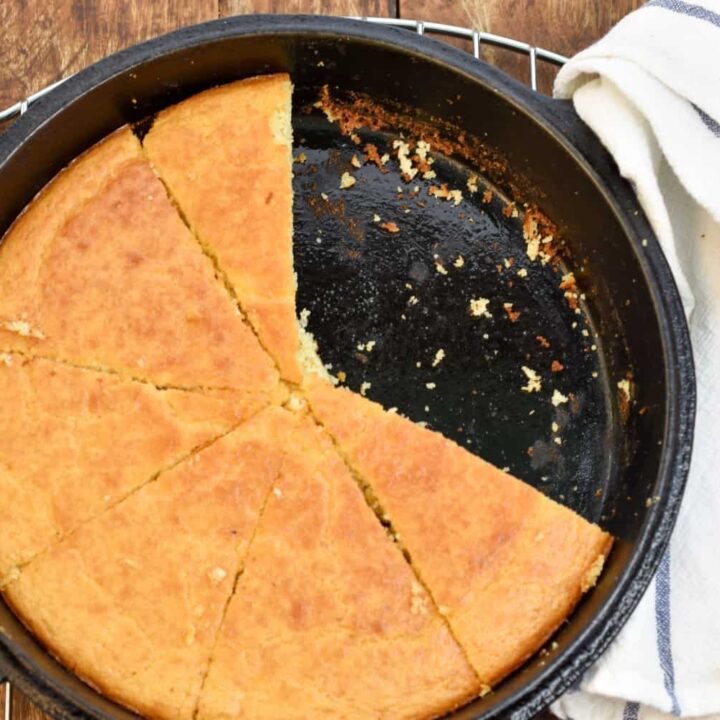 keto coconut flour cornbread with slices missing in a cast iron skille