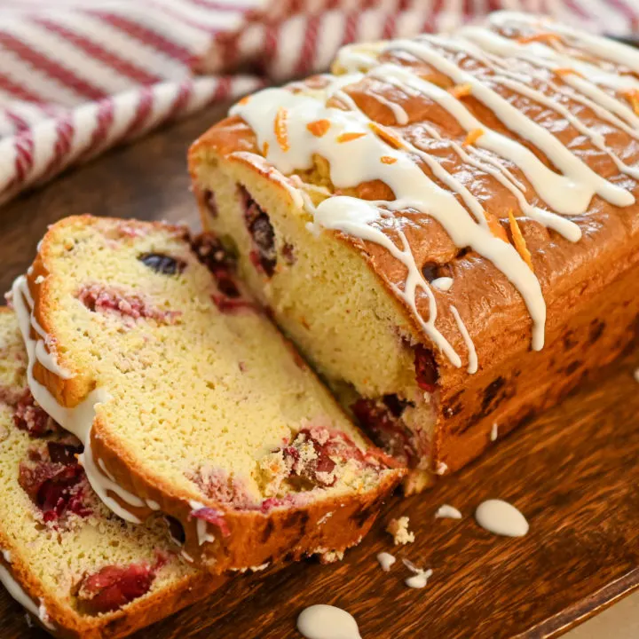 keto cranberry orange bread featured sliced on a wood board