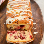 keto cranberry orange bread on a wood oval tray