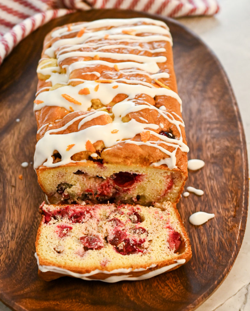 keto cranberry orange bread on a wood oval tray