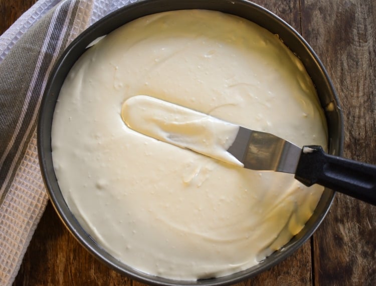 spreading cheesecake batter into a pan