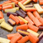 keto carrots being roasted in a baking sheet