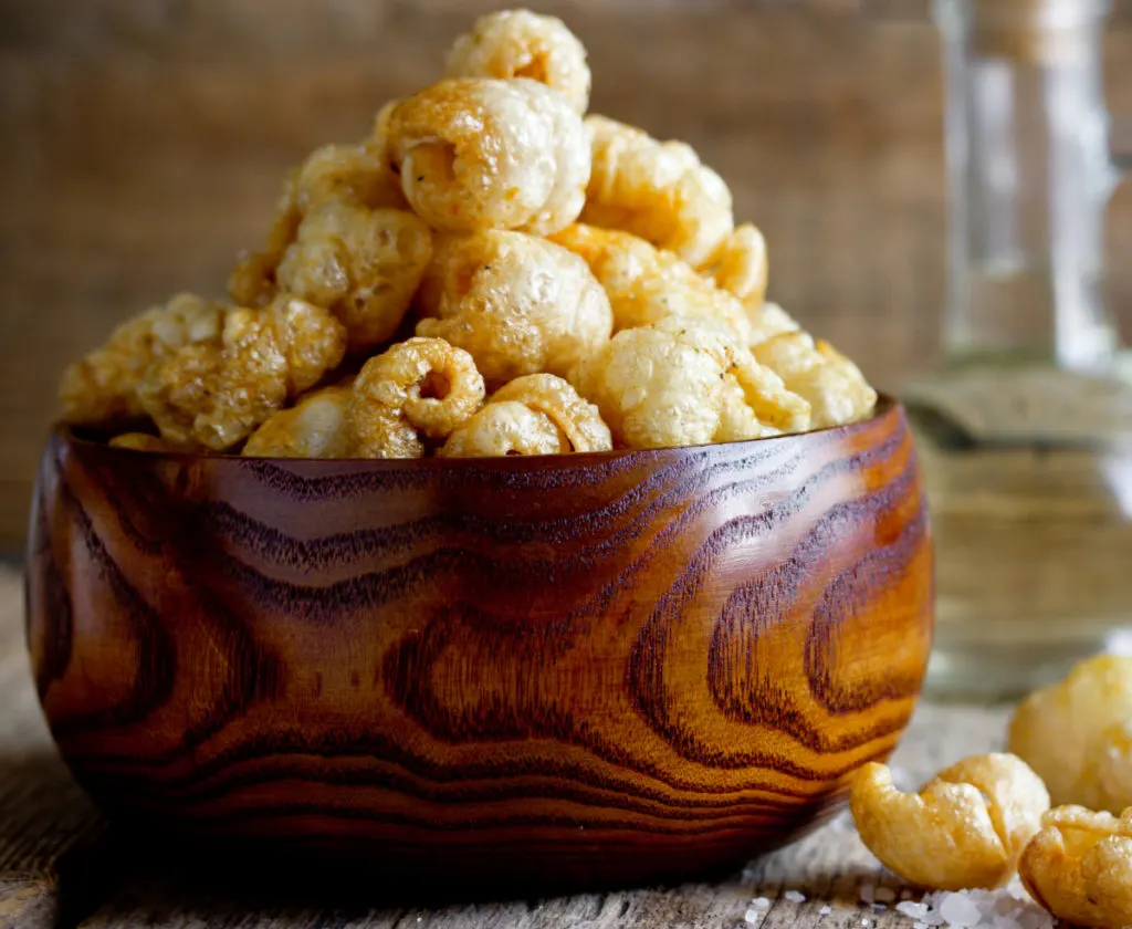 Puffy pork rinds in a wooden bowl