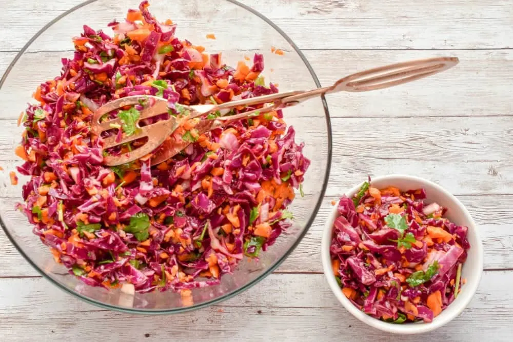 This Keto Red Cabbage And Carrot Slaw recipeÂ isÂ the perfect spring & summer side dish. It features a tangy apple cider vinaigrette that keeps this slaw light, crunchy, and slightly spicy. Â It's a refreshing salad that packs a lot of nutrition. Â 