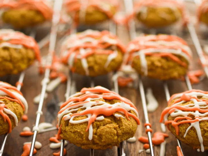 Gluten-free pumpkin cookies on a baking rack allowing the icing to set