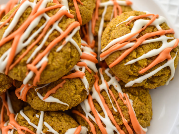 Keto pumpkin cookies stacked on a white plate