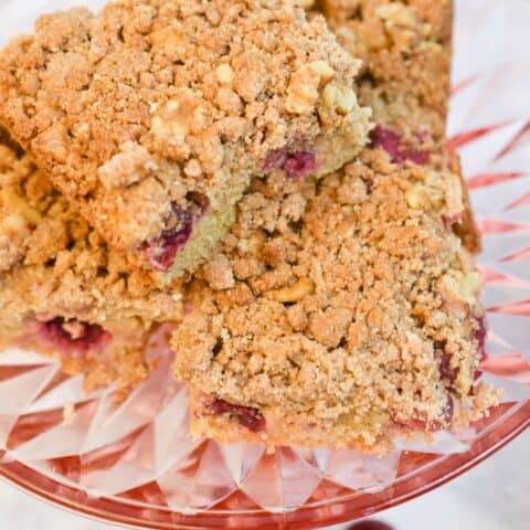 keto cranberry coffee cake on a pink cake plate