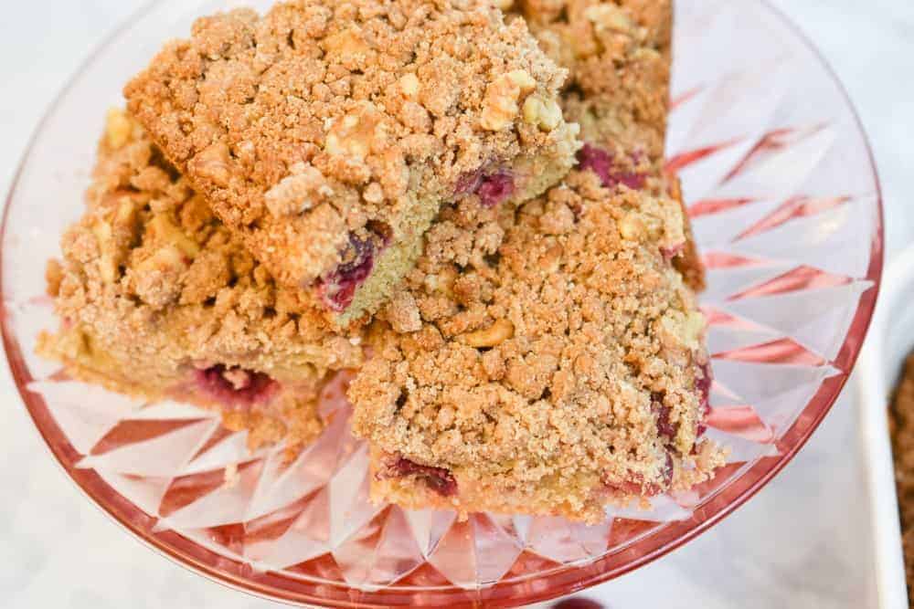keto cranberry coffee cake on a pink cake plate