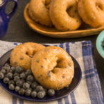 keto blueberry donuts served on a small blue plate with fresh blueberries