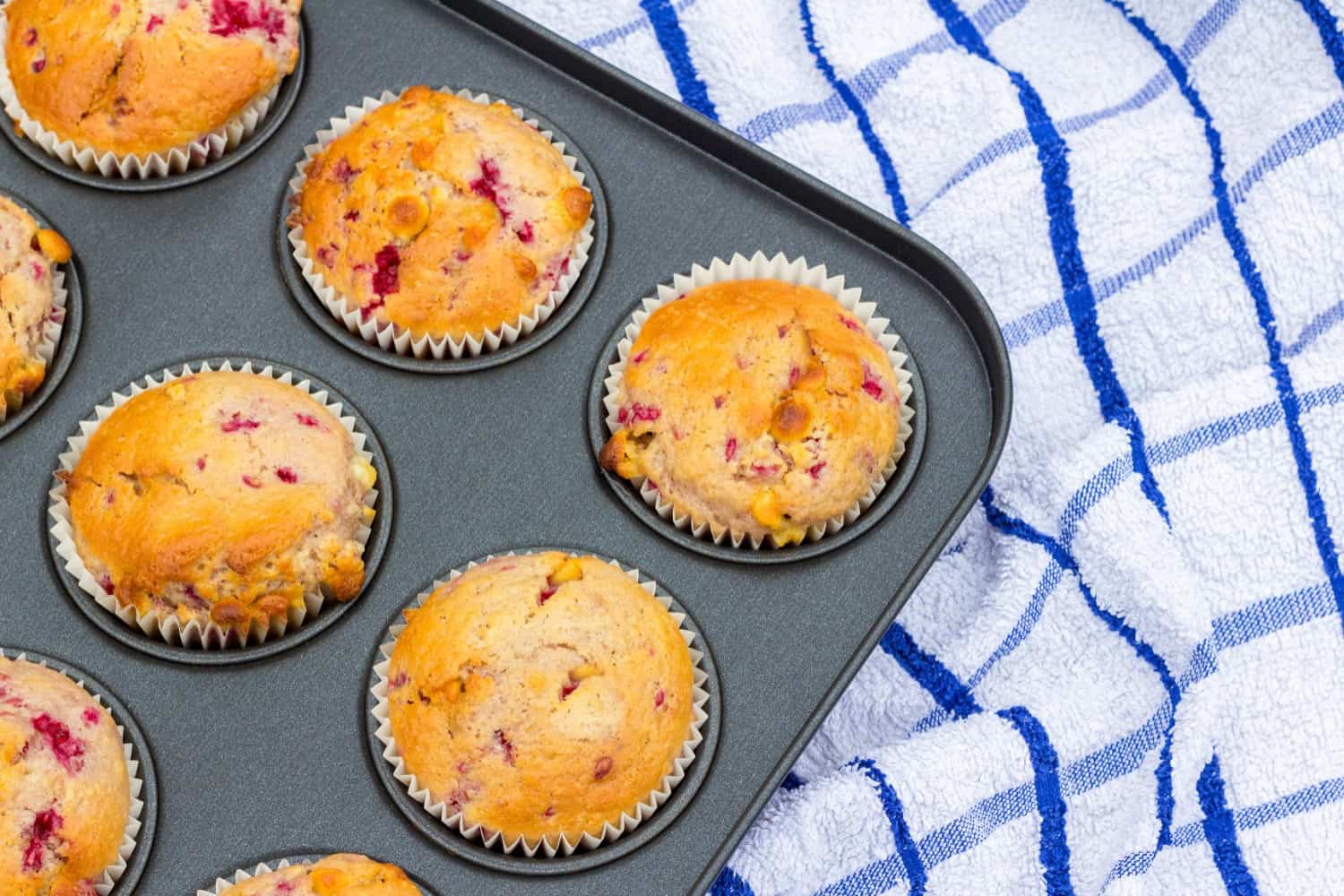 low carb raspberry muffins in a muffin tin cooling