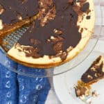 low carb marble cheesecake on cake stand and with a slice next to it.