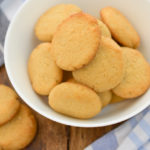 keto vanilla wafers in a white bowl with a blue and white cloth napkin next to it
